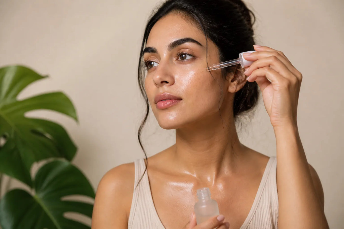 Woman with medium olive skin applying serum