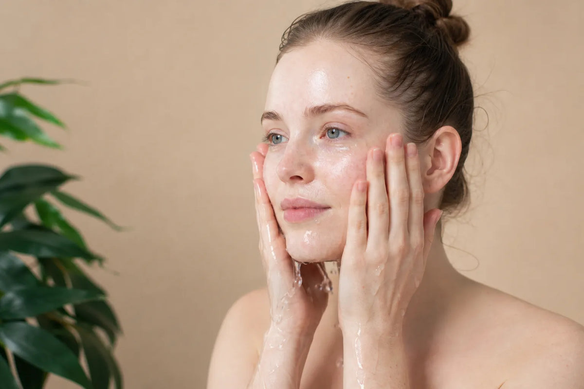 Woman with very fair skin washing her face